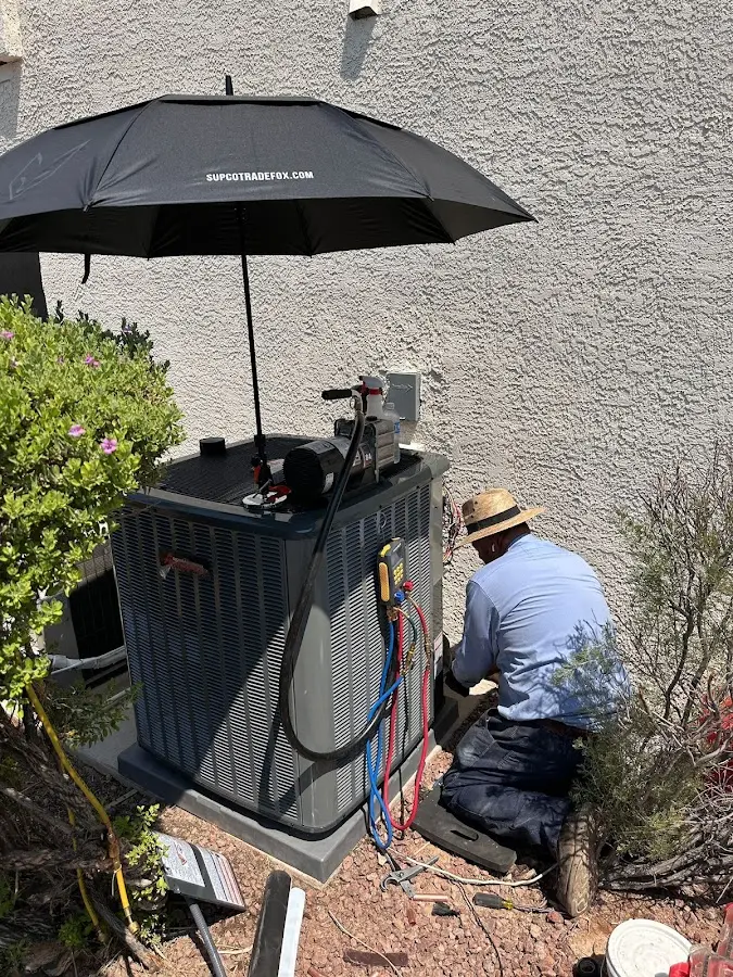 HVAC technician performing outdoor AC maintenance in Limerick
