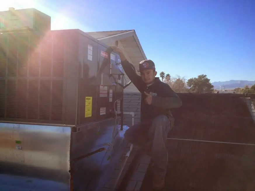 HVAC technician performing AC Tune-Up on a rooftop unit in Limerick